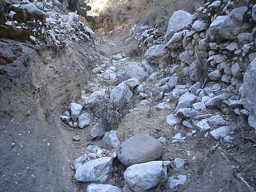 Dry riverbed with many stones.
