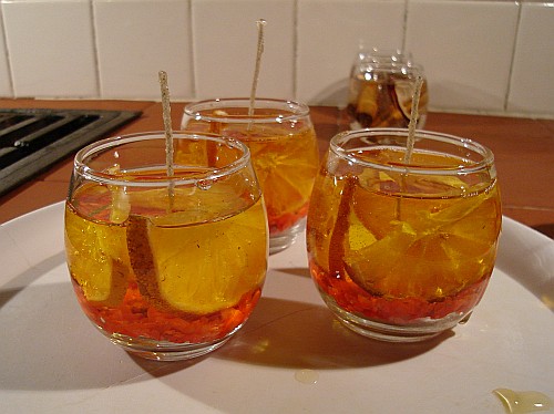Scented gel candles with dried orange slices.