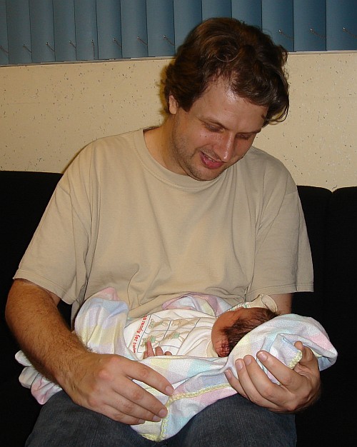 Happy father John holding Alice.