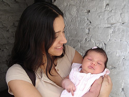 Esme holding Alice in the door opening of our house.