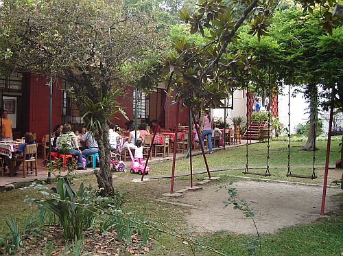 A part of the garden of the vegetarian restaurant and the restaurant itself.