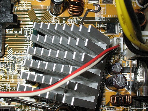 Carefully remove the dangling heatsink by unhooking 