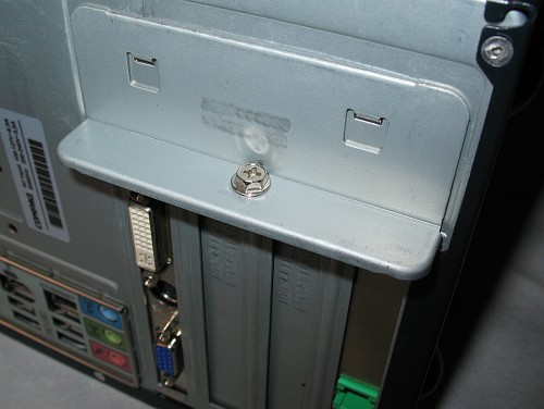 PCI locking bar securing the AGP video card (left), and fax-modem card (right).