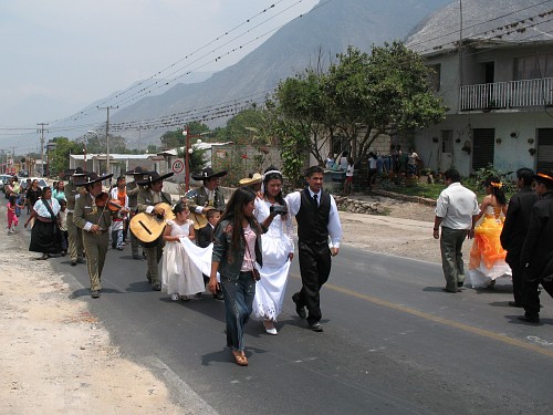 A traditional Mexican wedding walk and a Quinceaera walk passing each other in Acultzingo.