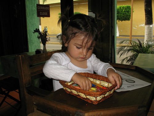 Alice playing with wax crayons at "Dany's Pizza & Sushi".