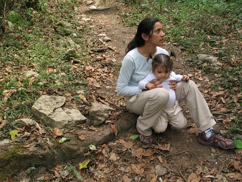 Esme and Alice sitting next to a tarantula habitat.