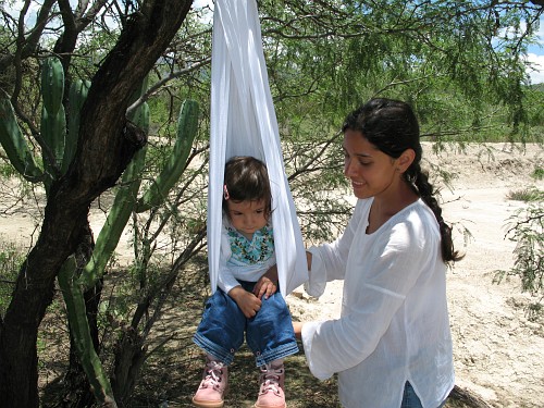 Alice in a makeshift swing, made out of a rebozo.