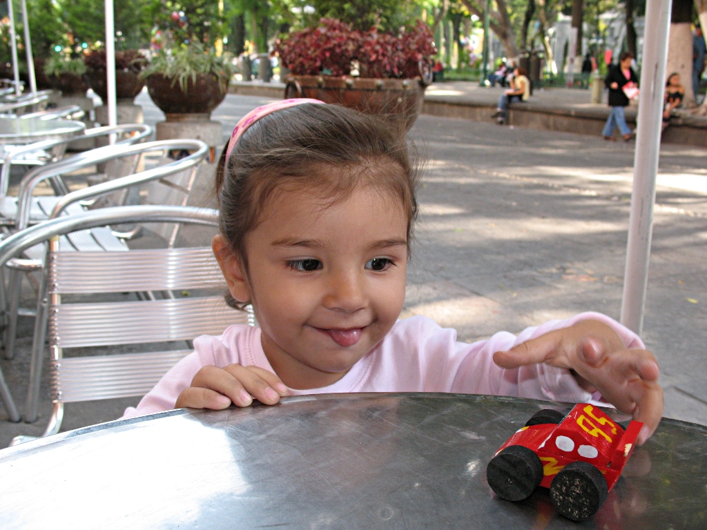 Alice playing with a wooden car, Zcalo of Puebla city