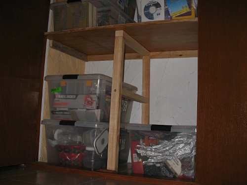 Shelve supported with wooden frame carrying boxes.