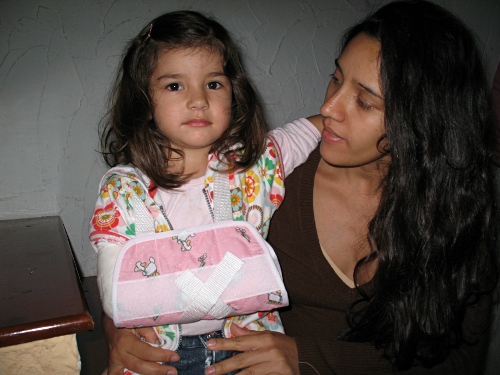 Alice, with broken arm, and Esme sitting on the stairs.