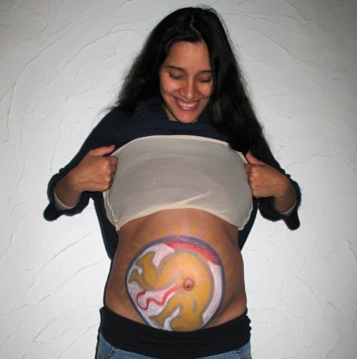 Esme showing the drawing Naol made on her belly.