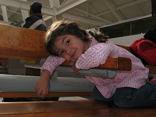 Alice hanging on a bench at CAXA, holding a pom-pon.