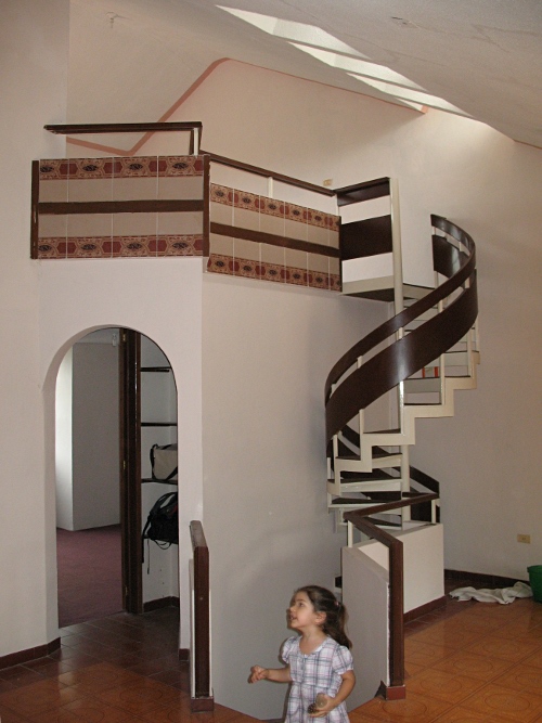 Living room, with spiral stairs leading up to the "studio".