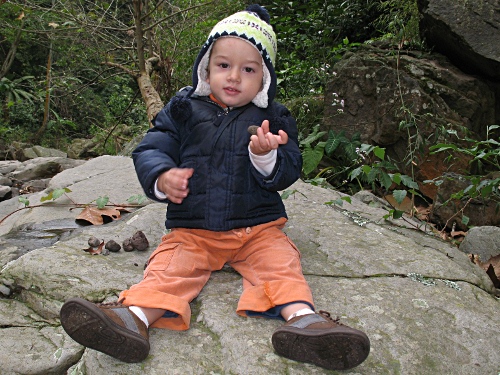 Adam holding a pebble.